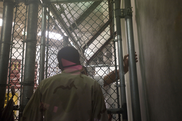 A detainee having a discussion with a guard in Camp 6 at the Guantánamo Bay Detention Facility in Guantánamo Bay, Cuba.