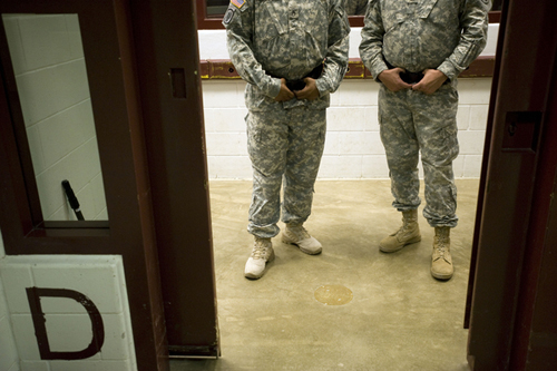 Camp 5 guards standing in the entrance to the spoke at the Guantánamo Bay Detention Facility.