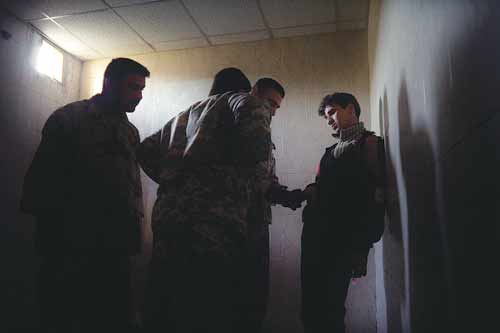 A Sunni man is detained by a Shiite-dominated army force at a JSS in the Mansour district of Baghdad.