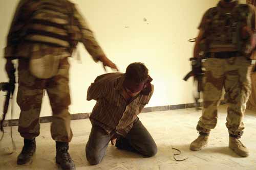 Iraqi Army soldiers detain Ziad Sabah Jasim.