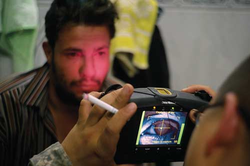 American soldiers take a biometric scan of Ziad.