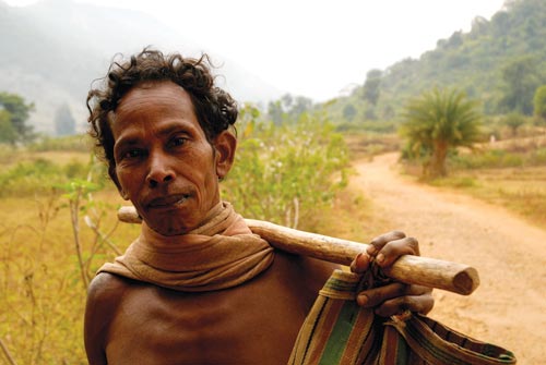 Bare-chested Man Carrying Stick