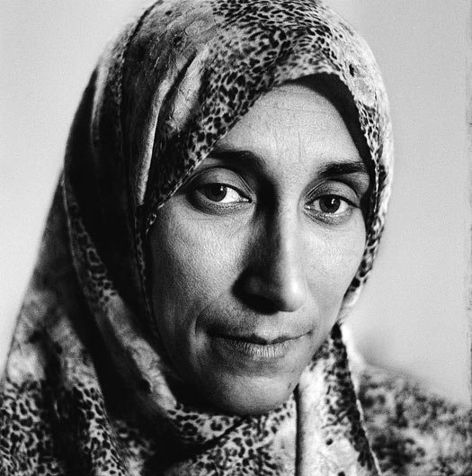 A woman with a long face and a headscarf.