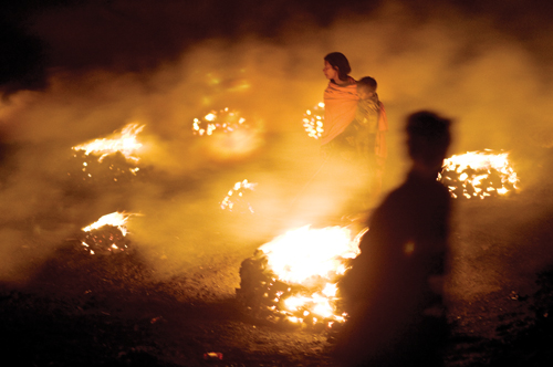 People burn coal in Bokahapadi Village, Jharia, Jharrkhand, India.