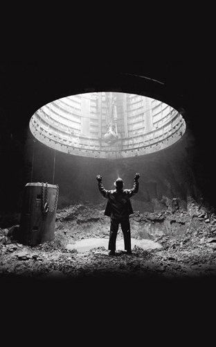 Shaft miner at the 2,500-foot-level station before mucking and drilling, Louvicourt Mine, Val-d'Or, Quebec.