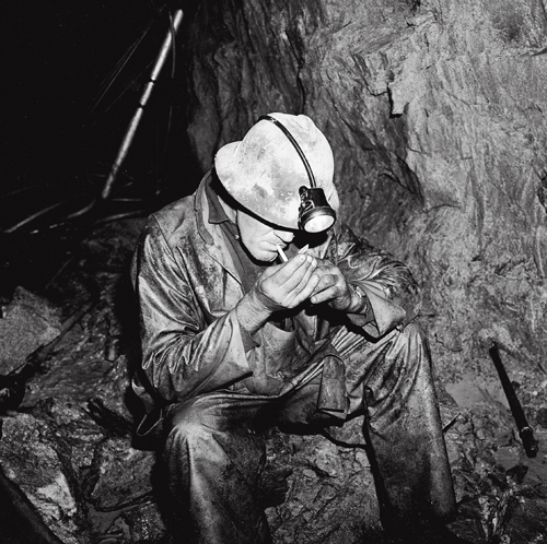 The late Lester Beattie smoking after drilling in a bypass drift at the 1,450-foot level of the Kerr Mine. Beattie suffered from 'white hand,' also known as Hand-Arm Vibration Syndrome.