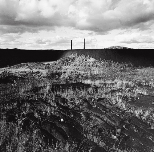 Slag heaps, smoke stacks, and rock blackened by decades of emissions from the Coniston Smelter, Coniston, Ontario.