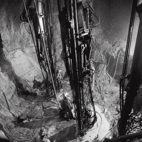 Shaft miners drilling a shaft with jumbo drills at the 2,500-foot level station of the Louvicourt Mine.