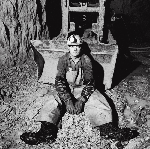 Steve Allen sitting in front of a Cavo 320 mucking machine at the 1,450-foot level of the Kerr Mine.