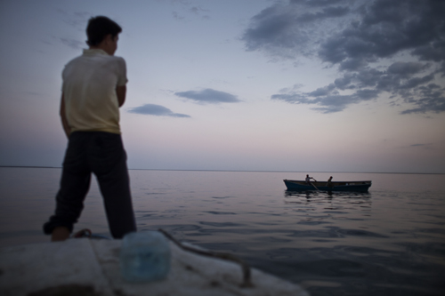 Fishermen from Tactubek cast their nets at dusk on the Aral Sea.