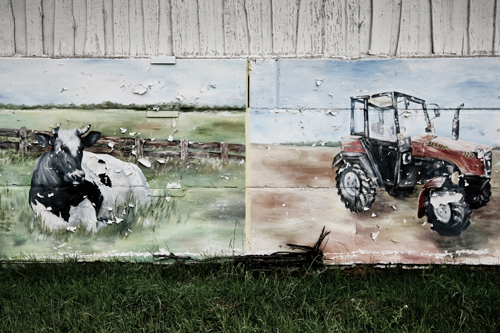 A mural tribute to the tractor, paint flecking from age.