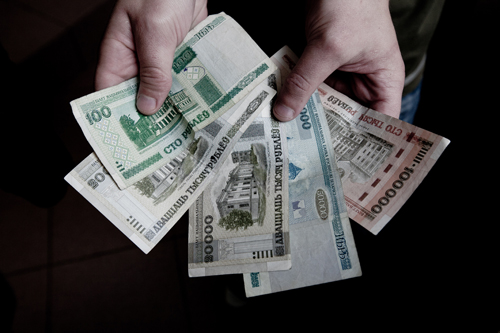 Hands holding Russian currency, newly printed prior to the elections to support Lukashenko's proposed "salary hike".