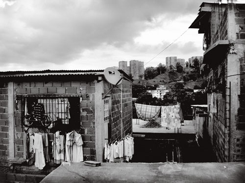 From her self-built house, erected on vacant public land, squatter Anayibe Sánchez has a view of the Valley of Caracas through the tangle of strung-up power lines and laundry hung out to dry.