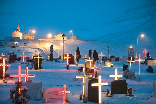 In Iceland's Westfjords region during the holidays, local cemeteries, like this one in Bolungarvík, are decorated with lights and illuminated crosses to commemorate the many, many local fishermen who have lost their lives at sea.