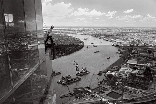 A construction worker looks out from the top of Vietnam's first skyscraper in downtown Saigon.