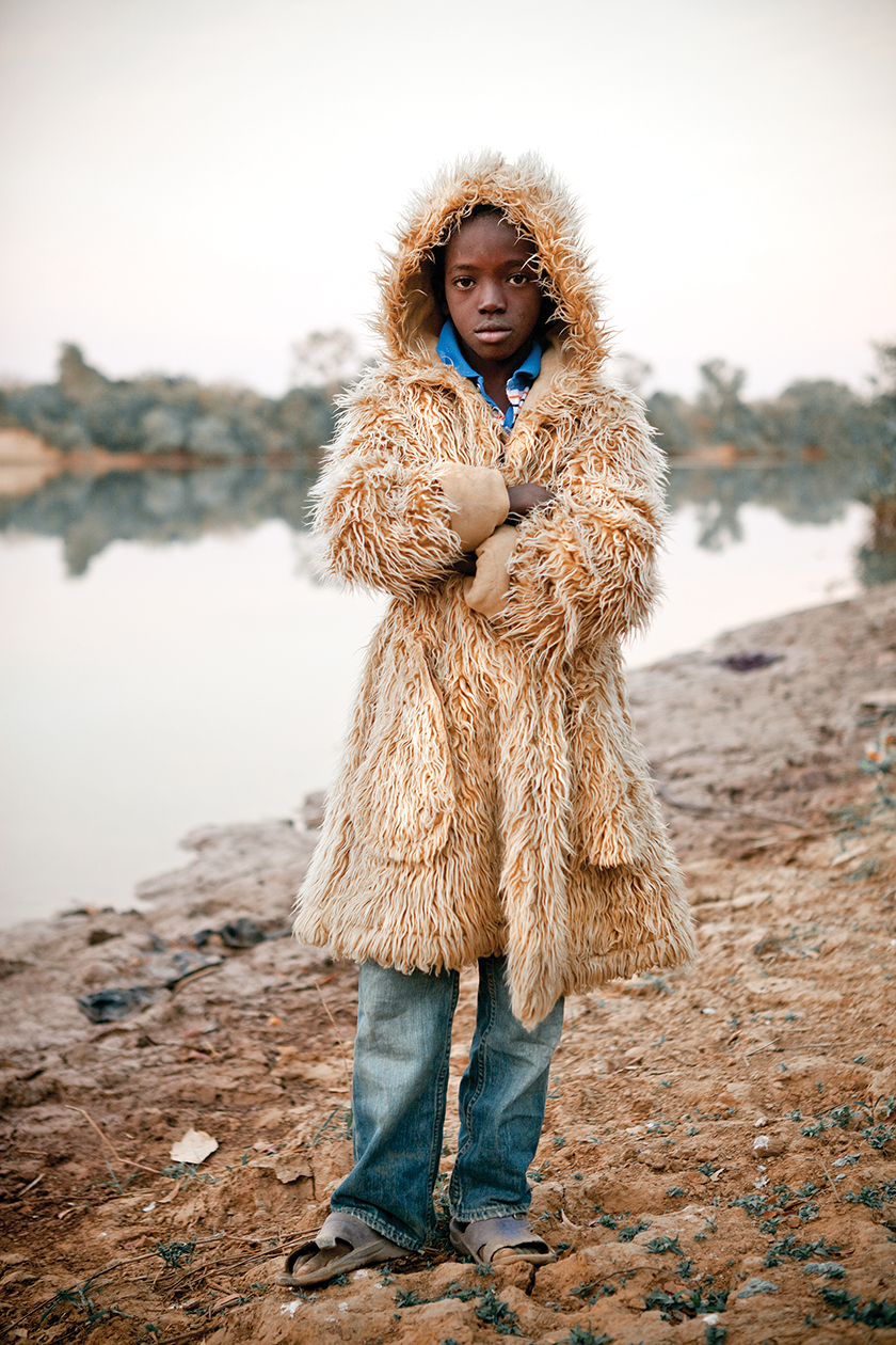 The son of Bakary Dabo, the Alkalo (village chief) of Diagabu Tenda, wearing a “fur” coat on a cool morning.