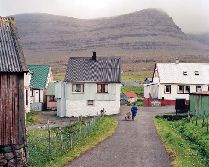 A farmer with his ewe and lamb on the island of Svínoy.