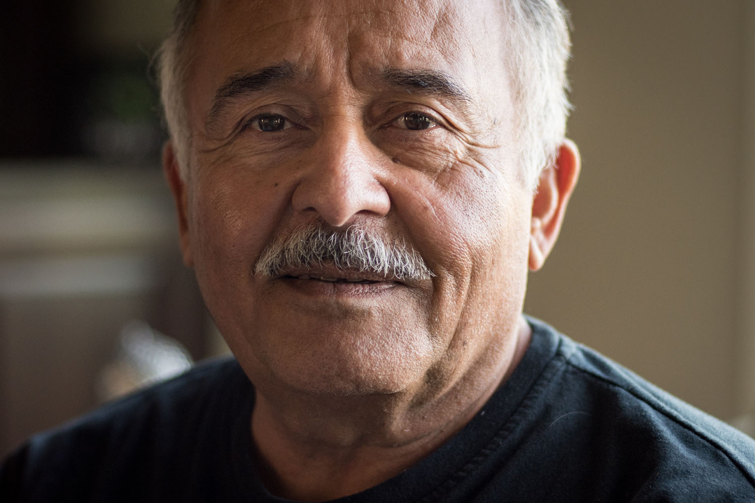 Abe Garza sits in his Tri-Cities home in September 2018. Photography by Sean McDermott.
