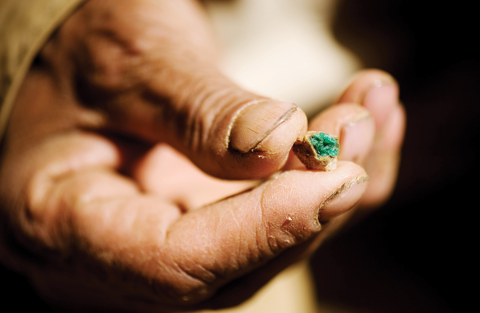 Commander Jalaluddin holds a low-grade emerald outside a dormant mine.