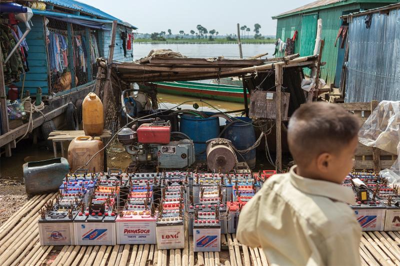 Car and truck batteries—a primary source of power for the majority of households in rural Cambodia—are recharged by a community  generator. (Thomas Cristofoletti/Ruom) 