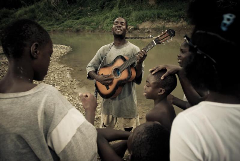 Lascelles sings church hymns by the river in Spanish Town.