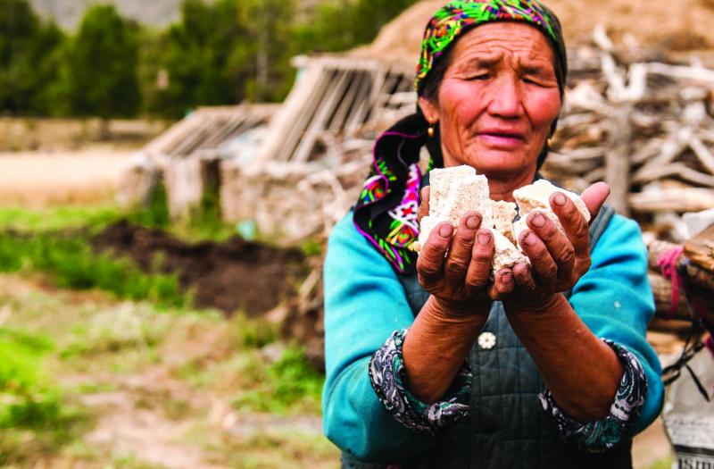 Mapesh, age fifty-seven, with goat cheese. Mapesh was born and raised in Hayndbulaktik, a village the park now intends to raze. (Rebecca Caldwell)