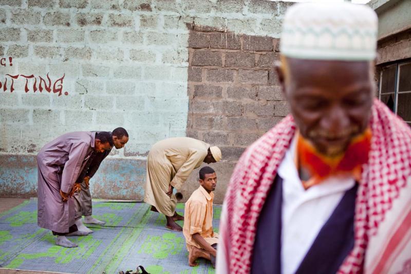 Muslim men at their afternoon prayers. Many of the older men henna-dye their beards.