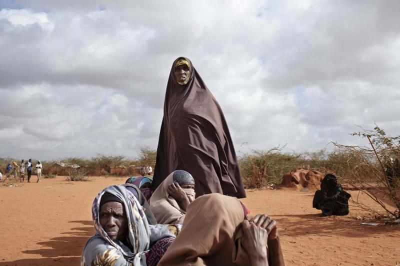 Refugees stand outside the Department of Refugee Affairs in the Dadaab Refugee Camp. (Adam Ferguson/VII/Corbis)