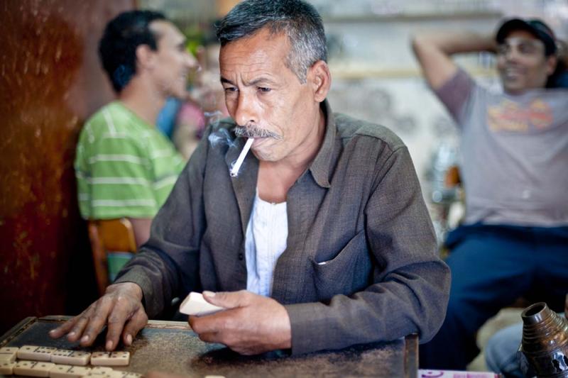 Boys and men of all ages pass their free time in Cairo’s numerous cafés. They smoke cigarettes and shisha while playing dominoes and cards and, until recently, avoiding talk of politics.