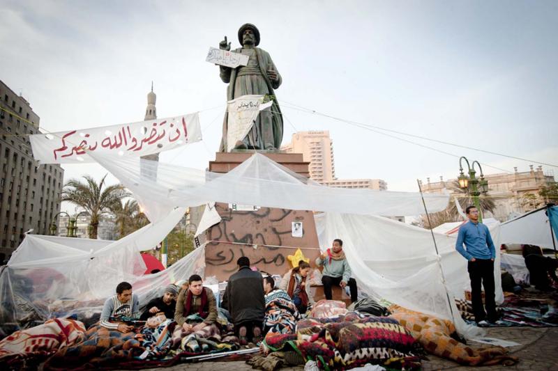 Protesters built temporary encampments in Tahrir Square, and hundreds of Egyptians, like these set up at the foot of the statue of Omar Makram, slept in the square at night.