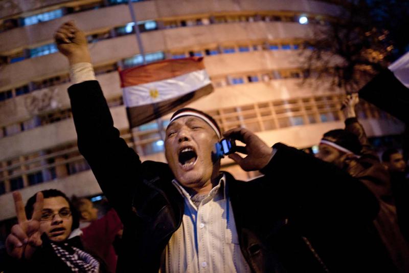 An Egyptian protester erupts in joy at the news—received via mobile phone—that President Hosni Mubarak would resign following eighteen days of protests.
