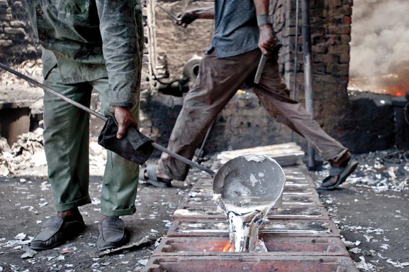 Aluminum smelters at a major informal factory melt down heaps of used aluminum foil to produce ten-kilo ingots, which are later used to produce cookware and silverware sold in Egypt's street markets.
