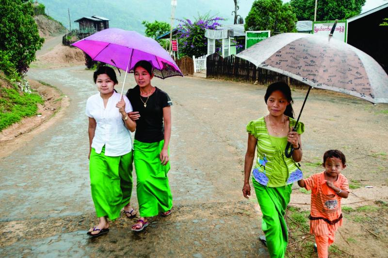 Villagers walk the main street of Layshee during one of the first showers of the rainy season.