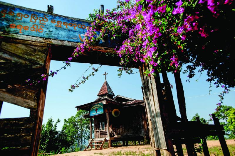 Bougainvillea hangs across the entrance to a Baptist church near Layshee. Almost everyone in the Naga Hills has converted to either Buddhism or Christianity.