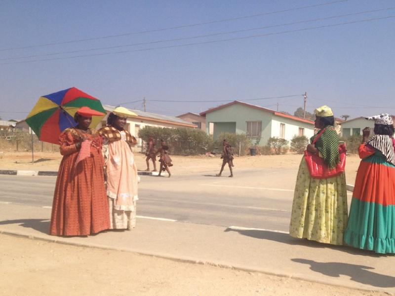 Herero and Himba women, cousins distanced by Namibia’s colonial legacy, display easy kinship on the streets of Opuwo. Photo by Catherine E. McKinley.