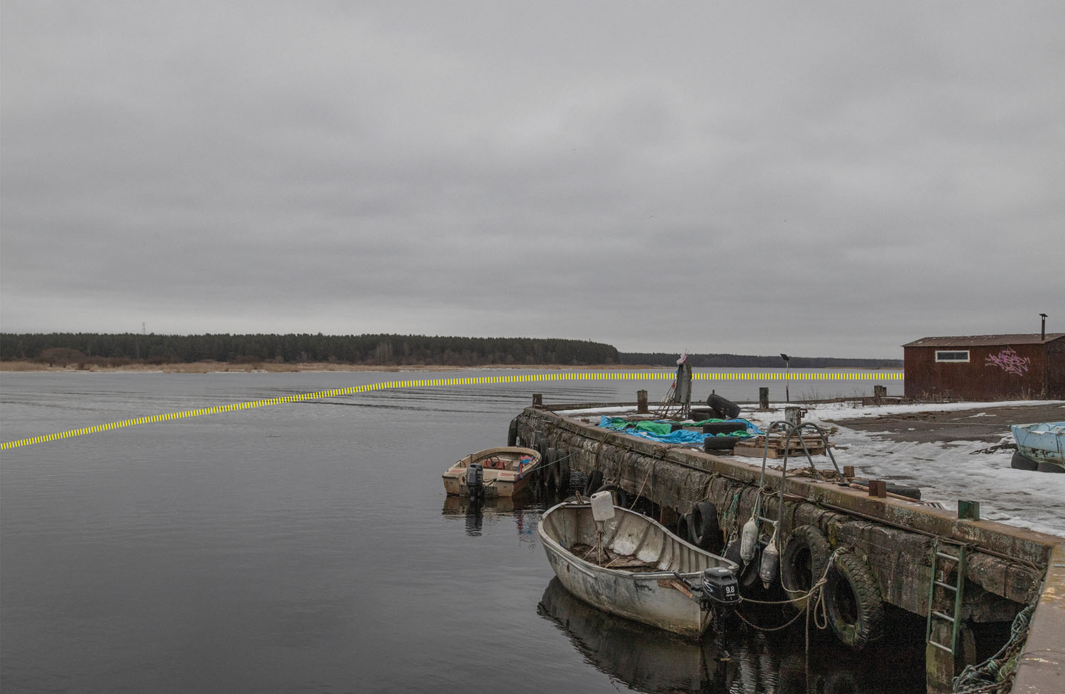 Russian river shore from the port of Narva-Jõesuu, on the Narva River. Narva-Jõesuu, Estonia, March 2025.