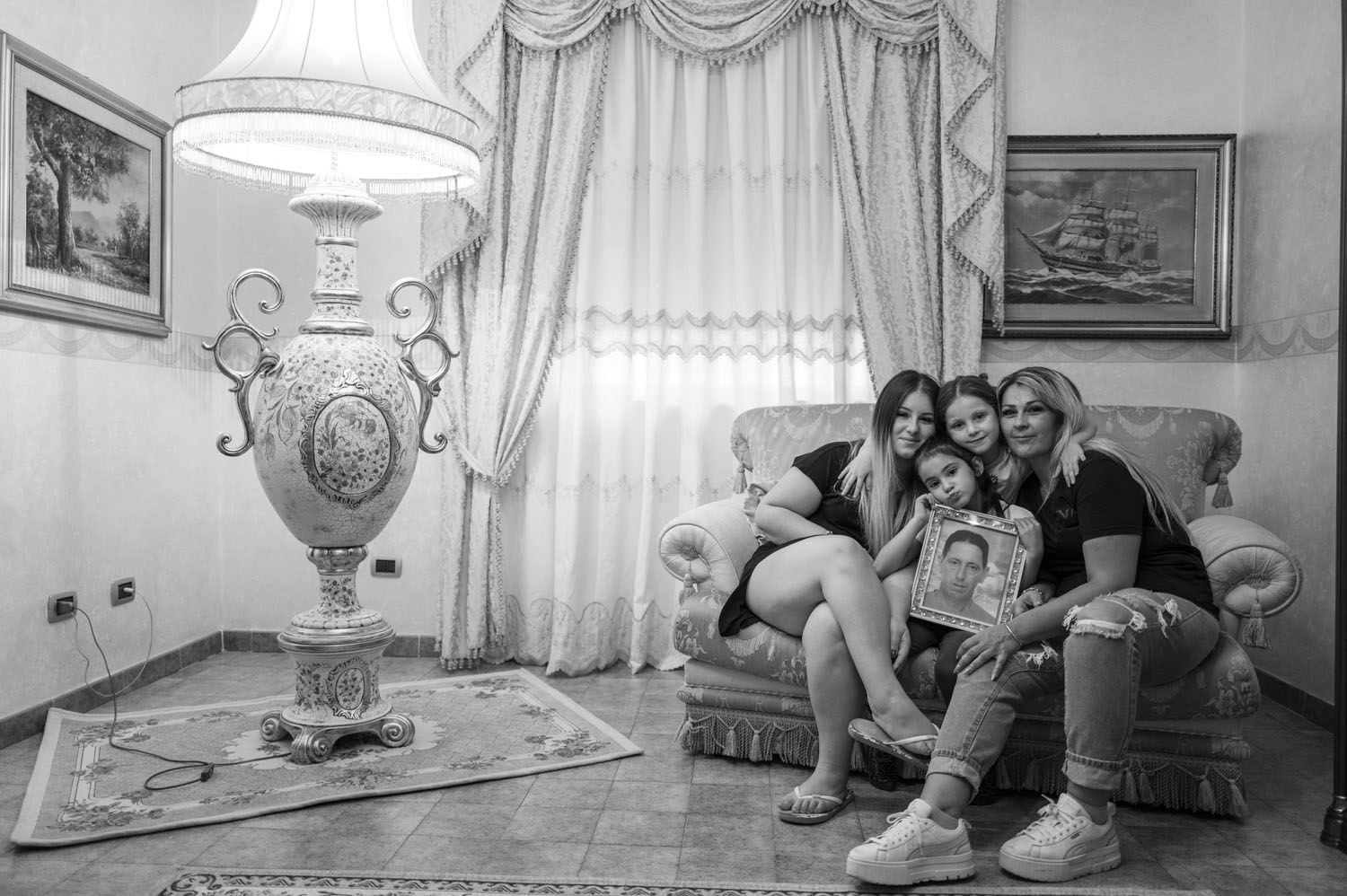 Alessandra Galeano and her three daughters, Evelyn (LEFT), Serena (CENTER), and Sophia (BOTTOM), holding a portrait of their father, Nuccio. September 2024.