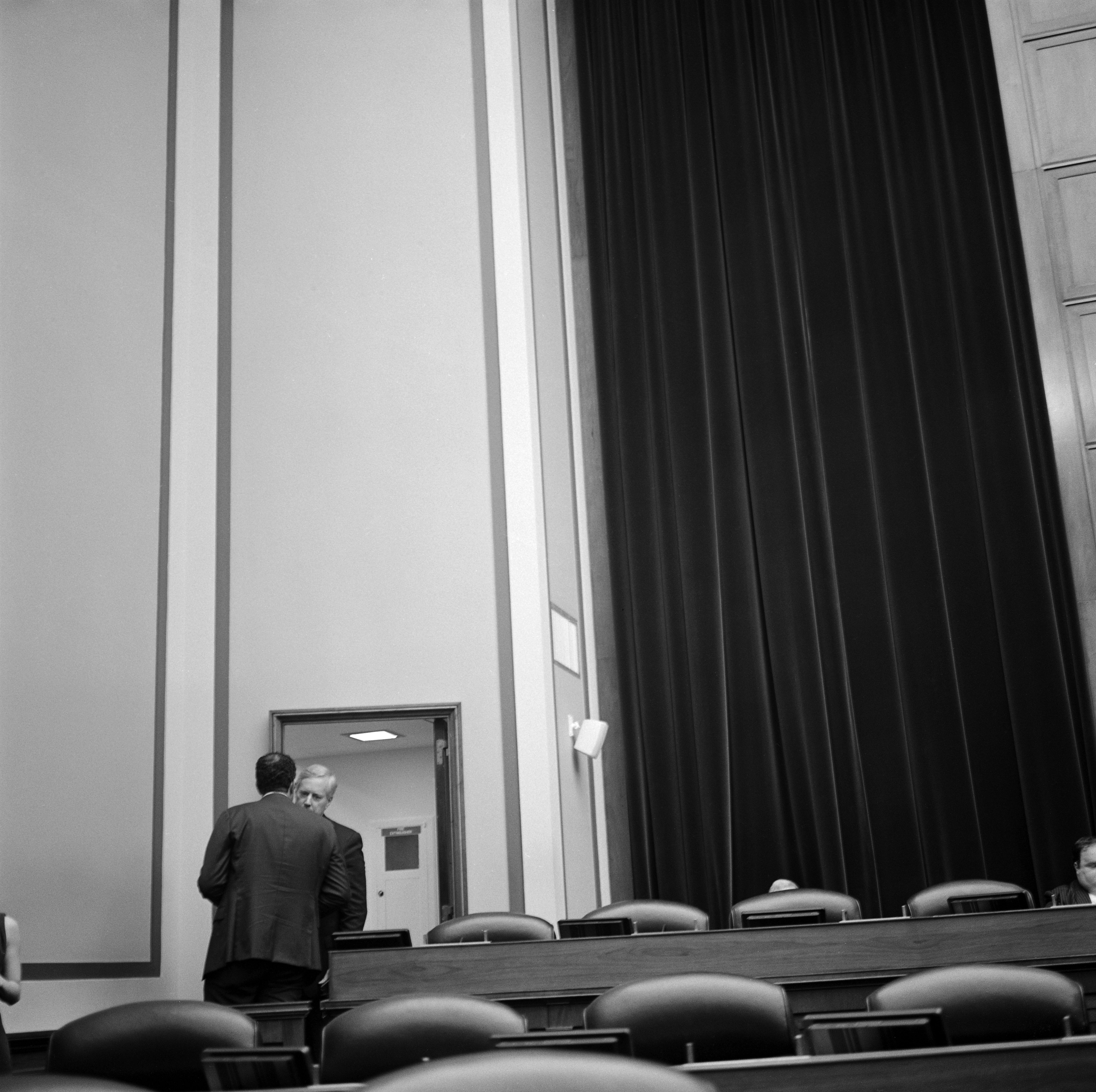 Two men in private conversation. 