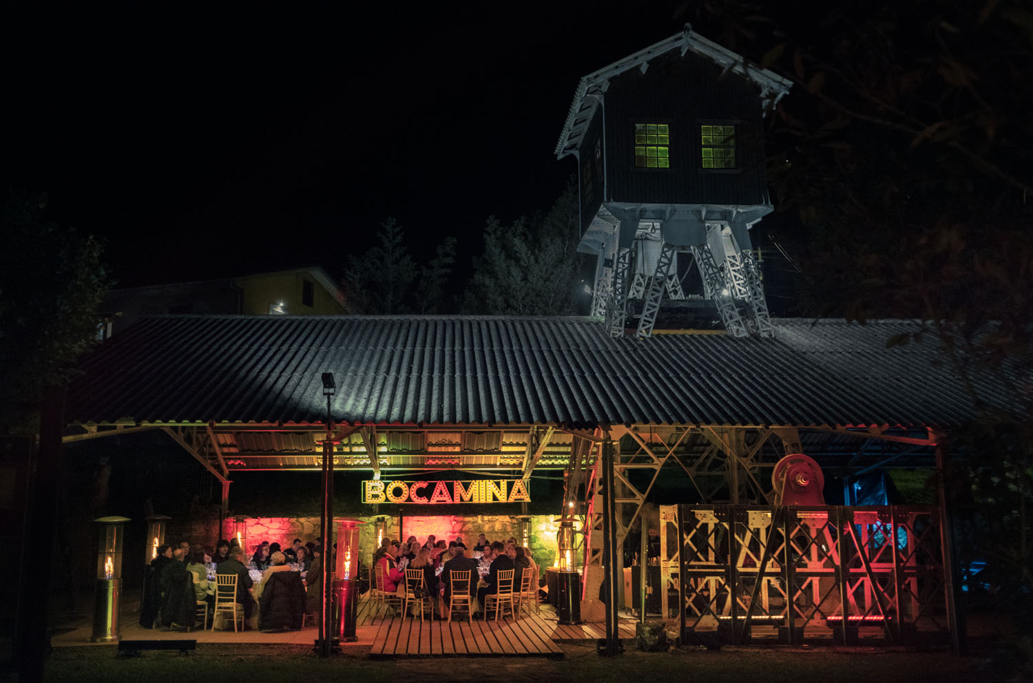 Dinner is served at an open air venue with a rooftop