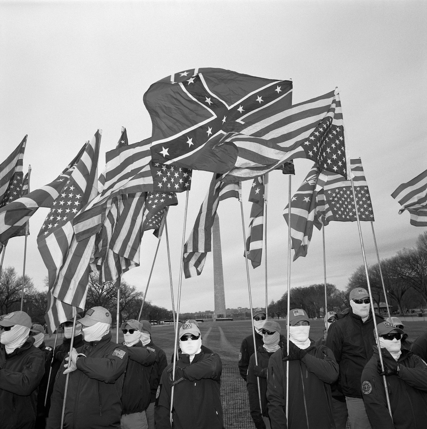 People wearing masks and holding flags.