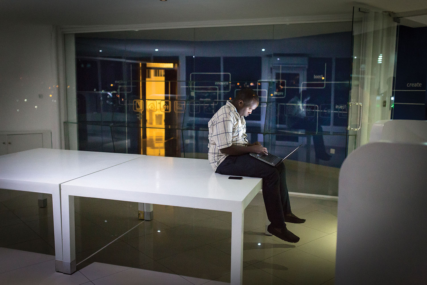 Timothee Mwizihire works late at the Kigali tech-incubator think. 