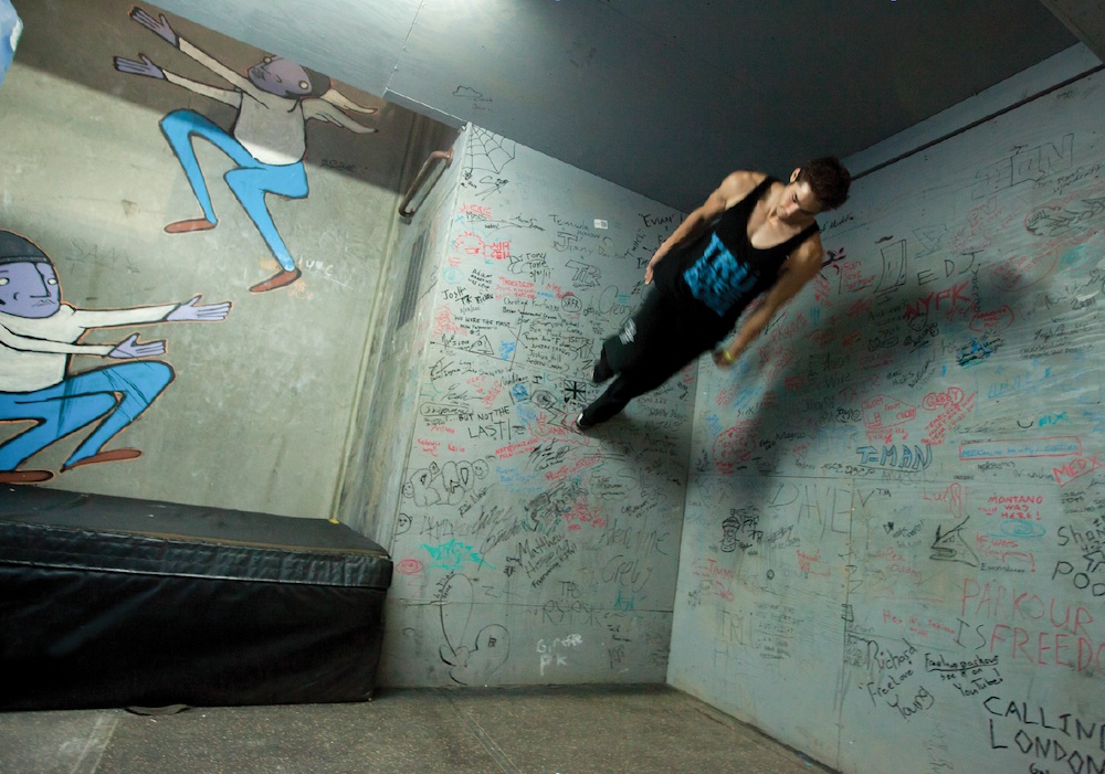 A free-runner with L.A.-based Team Tempest performs a move at their warehouse training facility. Originally from France, free-running emphasizes self-expression while negotiating obstacles and has been featured in many films in recent years. (Jason Motlagh)