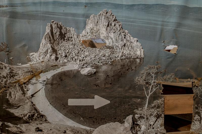 Jagged rocks with arrow pointing towards lake
