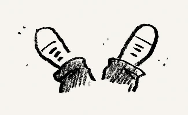 Pair of upturned legs, with only pants cuffs and shoes shown.