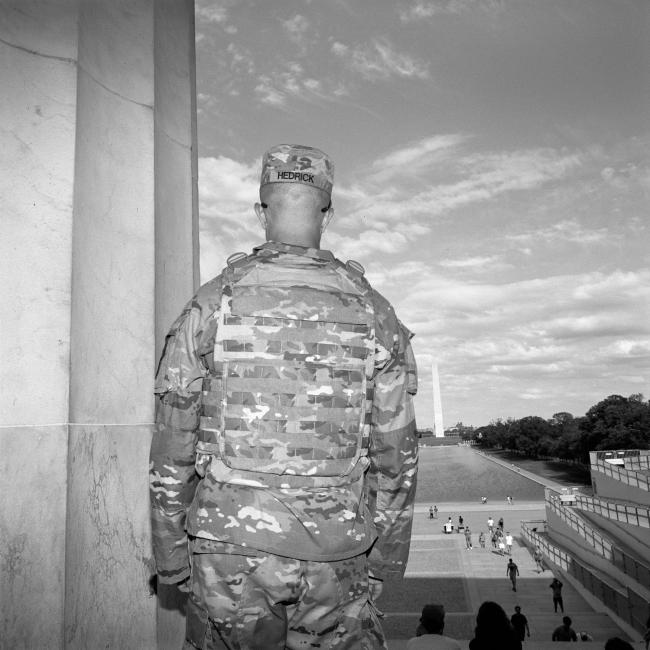 National Guard member looks over Reflecting Pool.