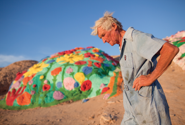 Leonard Knight walks near a foothill of the mountain.