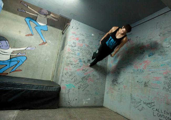 A free-runner with L.A.-based Team Tempest performs a move at their warehouse training facility. Originally from France, free-running emphasizes self-expression while negotiating obstacles and has been featured in many films in recent years. (Jason Motlagh)