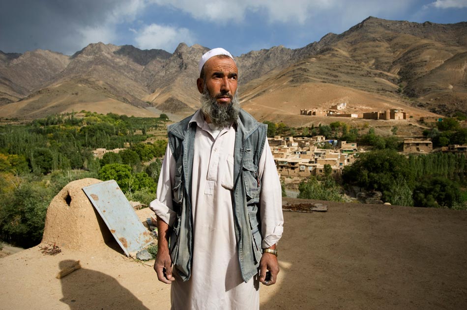 An Afghan civilian waits while a joint patrol of Afghan National Police (ANP) and US Army soldiers search his property in the Jalrez Valley, Wardak Province.