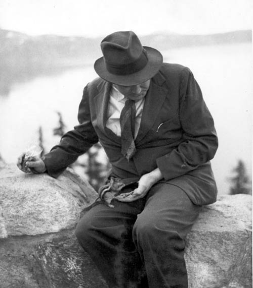 Thomas Wolfe feeds a chipmunk, Crater Lake National Park, Oregon, June 20, 1938. (Thomas Wolfe Collection, Pack Memorial Public Library, Asheville, NC.)