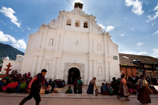 Several Indigenous Mayan Guatemalans wait outside the Catholic Church in the town of Almolonga for the K'iche' service, following the earlier Spanish service.